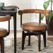Baxton Studio Delacruz Swivel Dining Chair - Round Open Back Accent Chair with Faux Leather Upholstery, Modern Contemporary Seating for Kitchen or Dining Room - BBT5547-Tan/Black-Armchair-DC